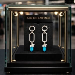 Silver chain dangly earrings with blue stone